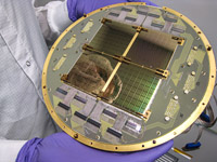 The BICEP2 telescope's focal plane consisting of an array of 512 superconducting bolometers, designed to operate at 0.25 K (0.25 degrees Celsius above absolute zero) in order to reduce thermal noise in the detectors.  The focal plane was developed and produced at NASA's Jet Propulsion Laboratory. (<i>Anthony Turner, JPL</i>)